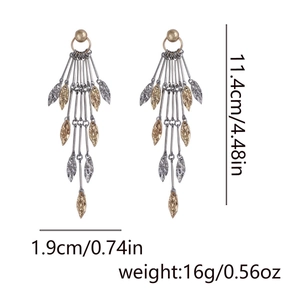 Detail of long metal leaf tassel earrings showing 11.4cm length and hammered texture
