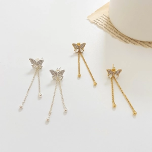 Detailed view of gold and silver butterfly tassel earrings with sparkling rhinestones