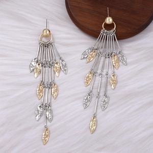 Detail of elegant gold and silver leaf tassel earrings with hammered metal textures