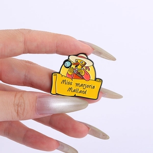 Cartoon detective duck enamel pin badge featuring Miss Marjorie Mallard on a hand