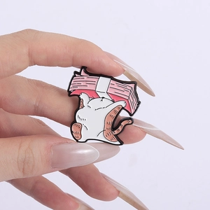 Detail of creative cartoon cat enamel pin with money icon held in hand for scale