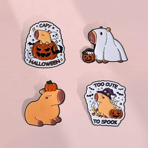 Detail view of cute Halloween capybara enamel pins with pumpkin and ghost motifs