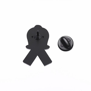 Detailed back view of metal brooch with matte black finish and secure rubber clutch