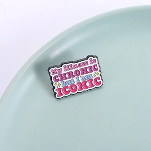 Enamel pin with 'My illness is CHRONIC but I am ICONIC' quote and star accents