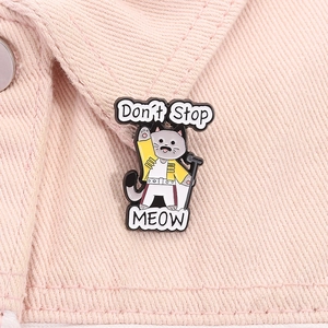 Cartoon cat Freddie Mercury enamel pin featuring Don't Stop Meow text on denim jacket
