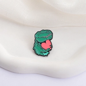 Cute green dinosaur enamel brooch holding a pink heart for creative clothing decoration