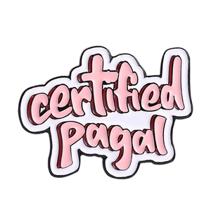 Detail of a white enamel pin featuring pink certified Pagal text with black outlines