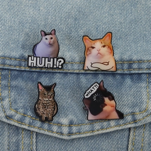 Funny cat meme enamel pins set on blue denim jacket featuring funny cat facial expressions
