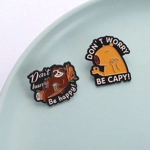 Funny cartoon enamel pins set featuring sloth and capybara with humorous slogans