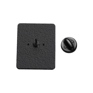 Detail view of the black matte metal badge back showing pin and rubber clutch attachment