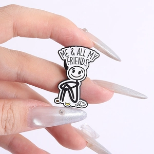 Close-up of funny enamel stickman brooch with ME & ALL MY FRIENDS text for clothing