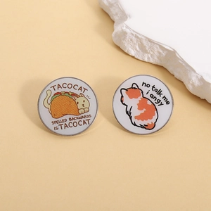 Cute set of two cat enamel pins featuring Taco Cat and Angy Cat on a yellow background