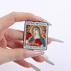 Cartoon enamel pin with Hail Mary boxing gloves design and humorous punch the devil text