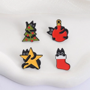 Nahaufnahme von vier festlichen schwarzen Katzen-Emaillenadeln auf weißem Display