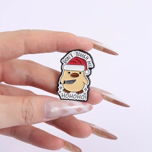 Funny Christmas duck enamel pin with don't touch my slogan and holiday hat held by hand