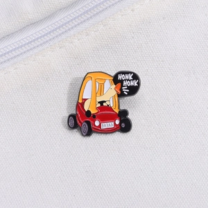 Macro shot of a cartoon white duck driving a tractor enamel pin on a white canvas background