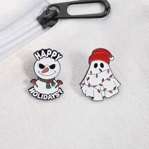 Christmas snowman and ghost enamel pins with Happy Holidays text on canvas fabric