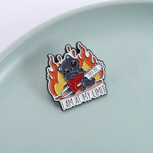 Cartoon black cat enamel pin with chainsaw and flame design and I Am At My Limit text