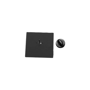 Detail view of the black enamel pin back with metal needle and rubber clutch backing