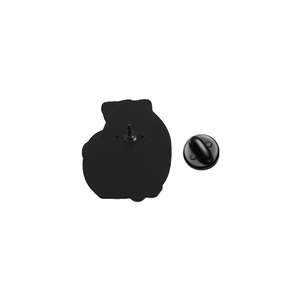 Detail view of the black matte metal brooch back with rubber pin clutch and needle closure