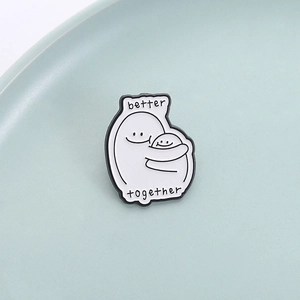 Minimalist enamel pin featuring two figures hugging with Better Together slogan