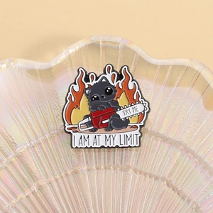 Funny black cat enamel pin with chainsaw and flames featuring I AM AT MY LIMIT text