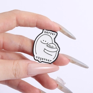 Minimalist enamel pin featuring cartoon figures hugging with Better Together quote