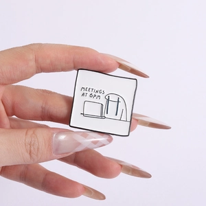 Detail of square Flork enamel pin showing stick man crying at computer with text