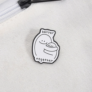 Detailed close-up of Better Together enamel pin on a white canvas bag texture