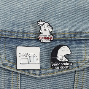 Detail of three funny Flork enamel pins featuring diverse memes on a denim jacket