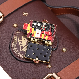 Detail of magic school suitcase brooch with glasses and scarf on leather background