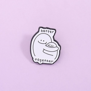 Minimalist enamel brooch with 'better together' text and two hugging figures on purple background