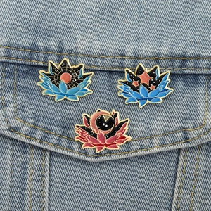 Starry sky lotus enamel brooch set with sun and moon elements on blue denim jacket