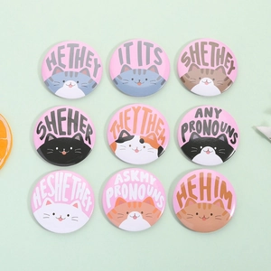 Set of nine cute cat pronoun tinplate badges with colorful feline illustrations