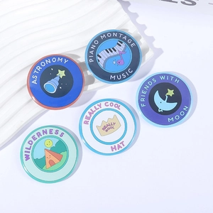 Flat lay of five creative cartoon illustration badges with astronomy and music themes