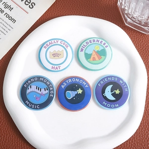 Set of five creative illustration tin badges featuring music and astronomy themes