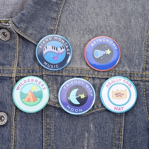 Set of 5 creative illustration tinplate pins on denim jacket featuring music and astronomy