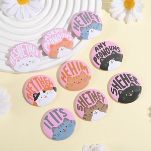 Set of 9 cute cartoon cat pronoun tinplate badges with pink background and diverse kitty faces