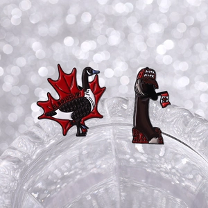 Detail of cartoon Honk goose enamel pins with maple leaf and Canadian flag