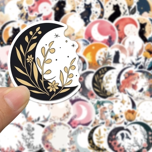 Close-up of decorative moon and flower stickers for journals and phone cases
