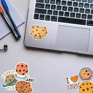 Close-up of waterproof cartoon cookie stickers on a laptop featuring Keep Life Sweet text