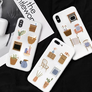 Nordic cartoon home decor stickers set displayed on white phone cases on black fabric