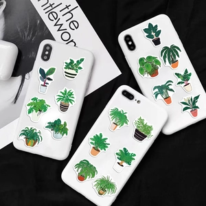 Detailed view of green potted plant stickers on a white phone case for DIY decoration
