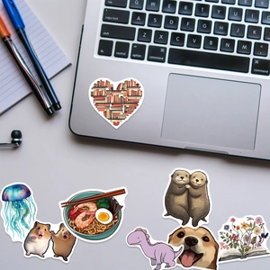 Detail of assorted creative stickers on laptop showing jellyfish, dinosaur and floral themes