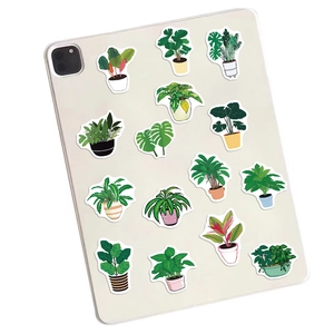 Green potted plant stickers on a tablet back with monstera and cactus illustrations