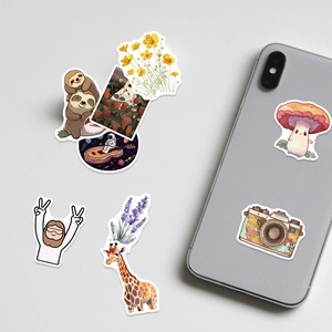 Detail of assorted vinyl stickers showing smooth white edges on a grey smartphone