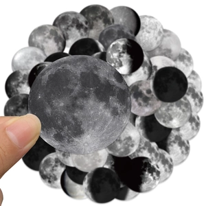Detail shot of moon phase stickers showing realistic lunar patterns for scrapbooking
