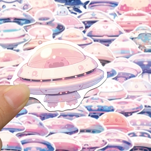 Close-up of pink cartoon UFO and spaceship stickers for DIY laptop and fridge decoration