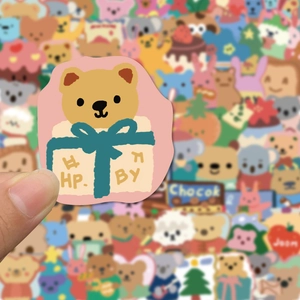 Cute brown bear sticker emerging from a yellow gift box for laptop and phone decoration