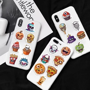 Dettaglio di adesivi a tema horror food su telefoni cellulari e oggetti di lifestyle